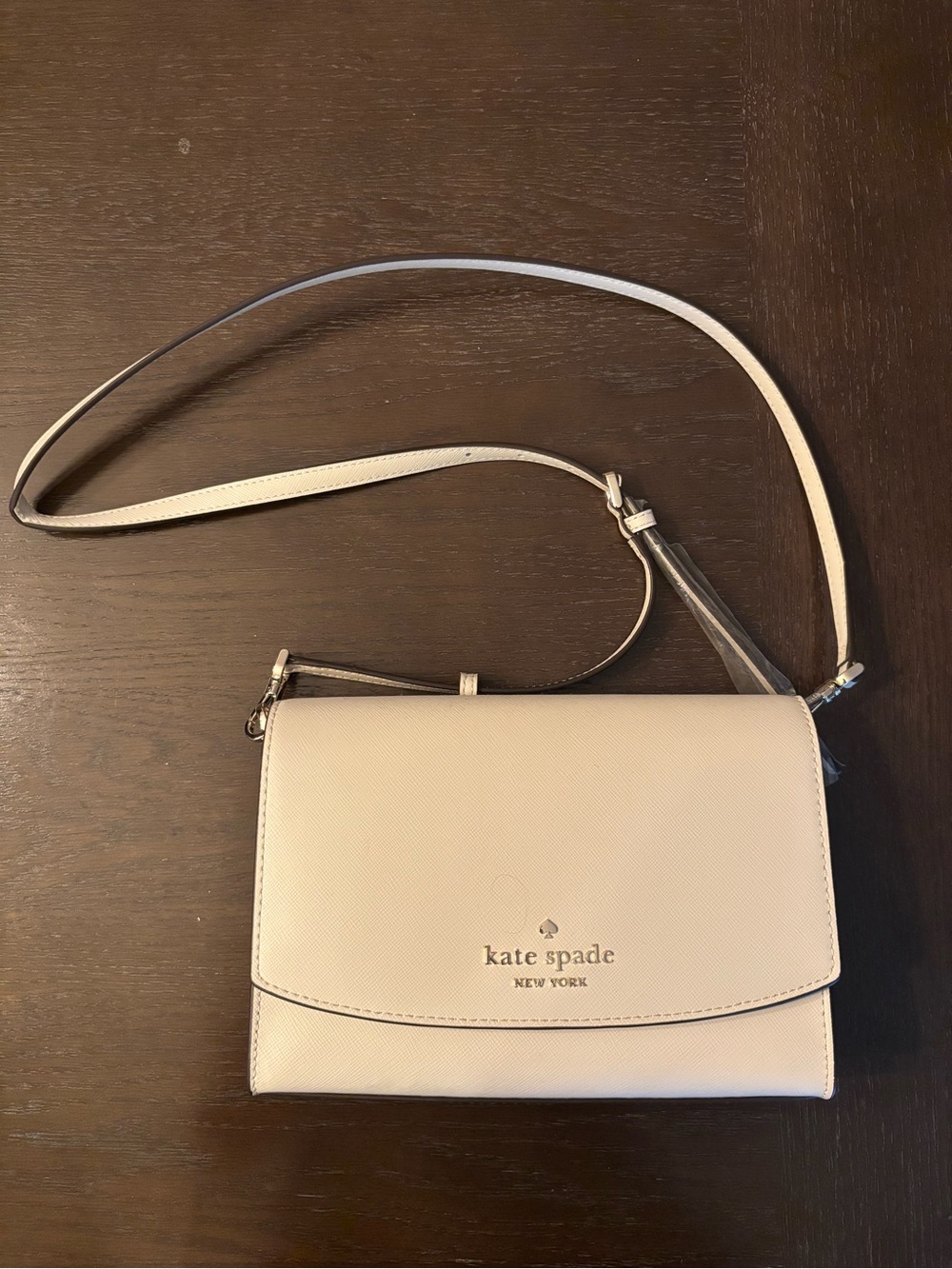 kate spade cream crossbody flap bag with gold logo